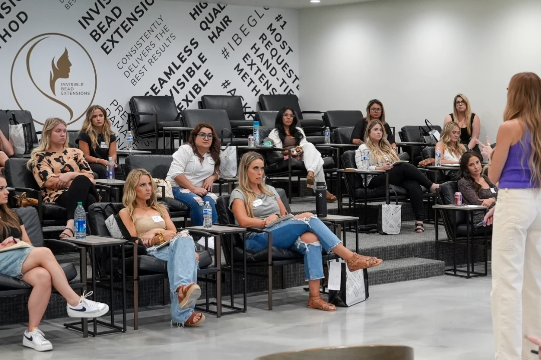 Cosmetology students and stylists attending an in-person class at IBE®